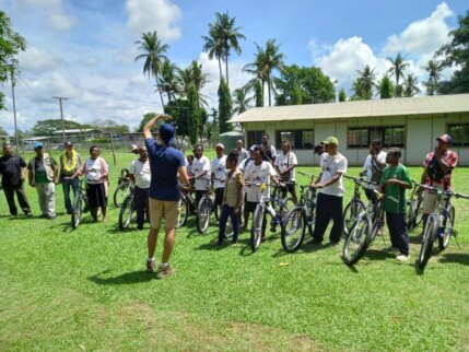 Children receiving books in a Pacific community